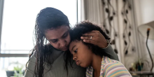Photo of mother hugging child. Photo credit: FG Trade/Getty